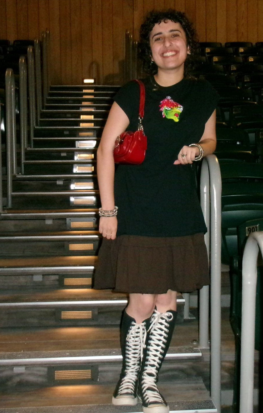 A young person standing on steps in a theater.